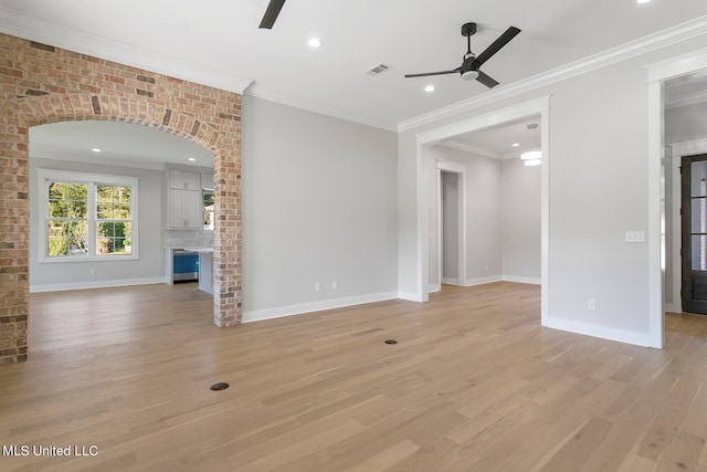 unfurnished living room featuring ceiling fan, ornamental molding, and light wood-type flooring