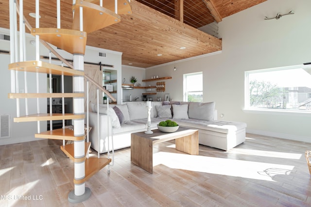 6717 Belle Fontaine Dr, Ocean Springs, MS 39564 - living area with baseboards, a barn door, wood finished floors, and wooden ceiling