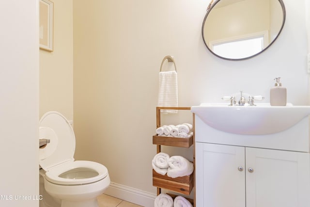 6717 Belle Fontaine Dr, Ocean Springs, MS 39564 - half bath with toilet, tile patterned floors, baseboards, and vanity