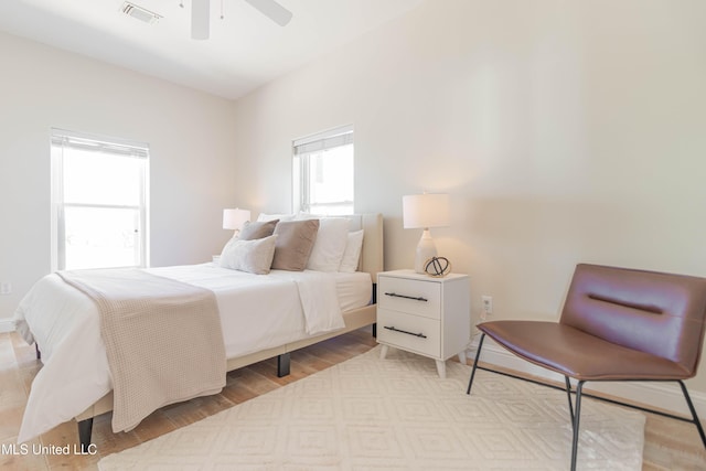 6717 Belle Fontaine Dr, Ocean Springs, MS 39564 - bedroom with visible vents, a ceiling fan, light wood-style floors, and baseboards