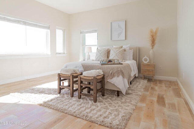 6717 Belle Fontaine Dr, Ocean Springs, MS 39564 - bedroom featuring light wood-type flooring and baseboards