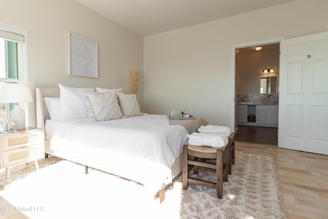 6717 Belle Fontaine Dr, Ocean Springs, MS 39564 - bedroom featuring light wood-style floors and ensuite bath
