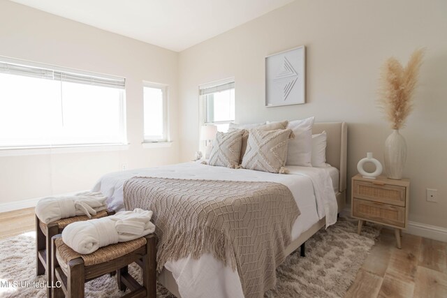 6717 Belle Fontaine Dr, Ocean Springs, MS 39564 - bedroom with baseboards and wood finished floors