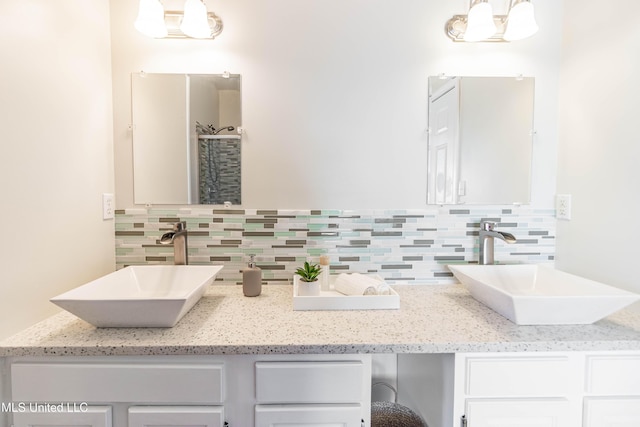 6717 Belle Fontaine Dr, Ocean Springs, MS 39564 - full bath featuring double vanity, a sink, and decorative backsplash
