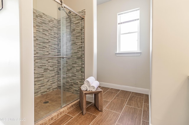 6717 Belle Fontaine Dr, Ocean Springs, MS 39564 - full bathroom featuring baseboards, a stall shower, and wood finish floors