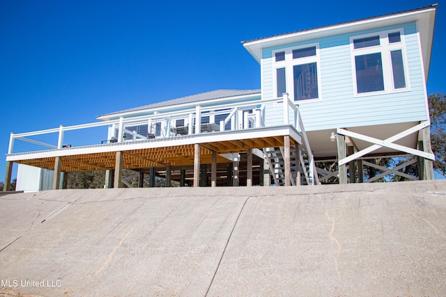 6717 Belle Fontaine Dr, Ocean Springs, MS 39564 - rear view of house with a wooden deck and metal roof