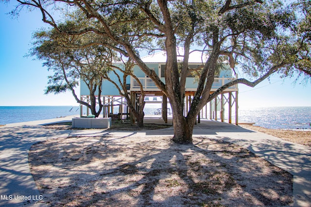 6717 Belle Fontaine Dr, Ocean Springs, MS 39564 - view of front of house featuring a carport, a water view, and concrete driveway