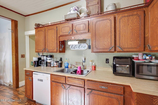 kitchen featuring dishwasher, dark wood-type flooring, crown molding, and sink