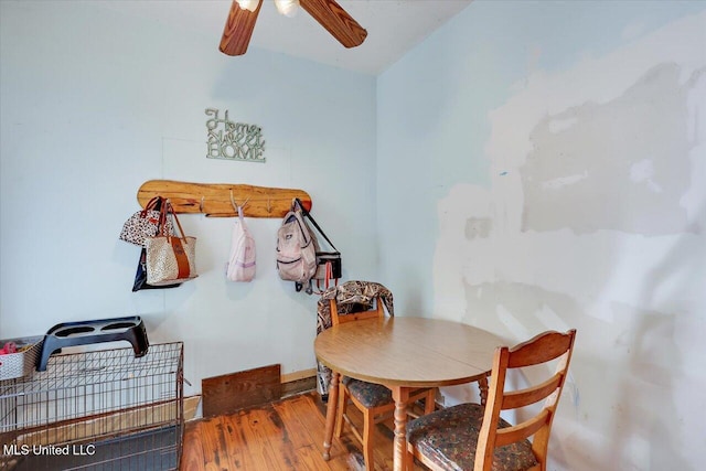 dining area with hardwood / wood-style floors, vaulted ceiling, and ceiling fan