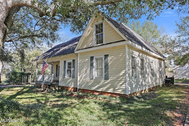 view of property exterior with a lawn and covered porch