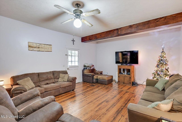 living room with hardwood / wood-style floors, ceiling fan, and beam ceiling