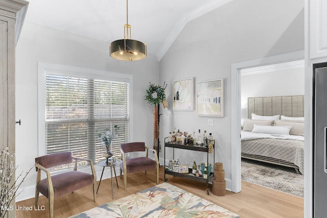 sitting room featuring light hardwood / wood-style floors and vaulted ceiling