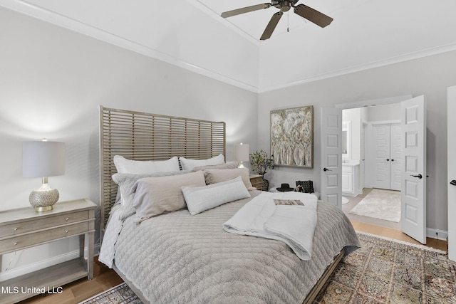 bedroom featuring ensuite bathroom, crown molding, vaulted ceiling, hardwood / wood-style flooring, and ceiling fan