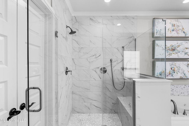 bathroom with crown molding and a shower with door