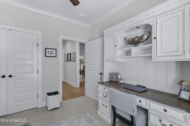 home office with light carpet, ceiling fan, and ornamental molding