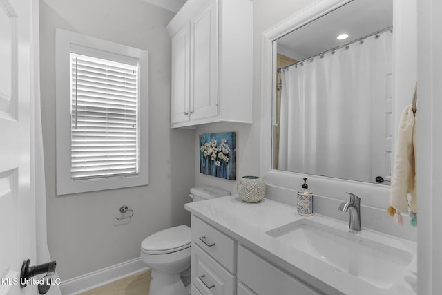 bathroom featuring vanity and toilet