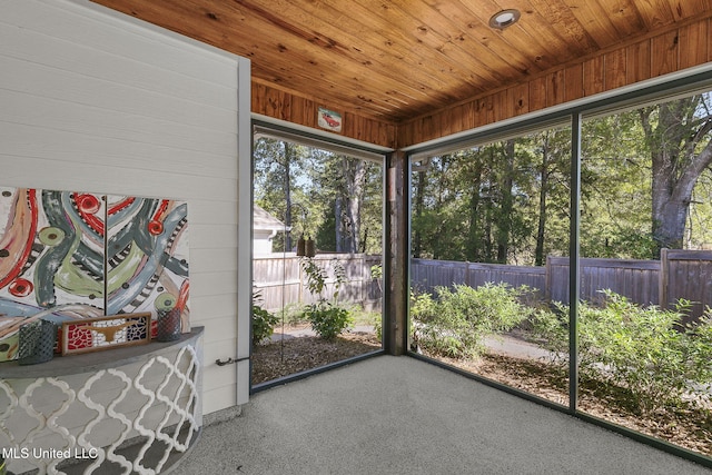 unfurnished sunroom with plenty of natural light and wooden ceiling