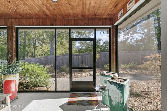 unfurnished sunroom with plenty of natural light and wooden ceiling