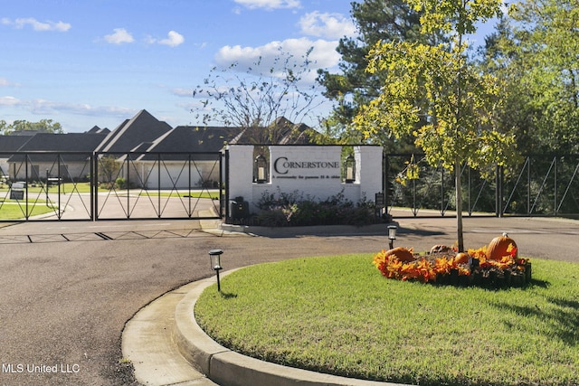 community / neighborhood sign with a yard