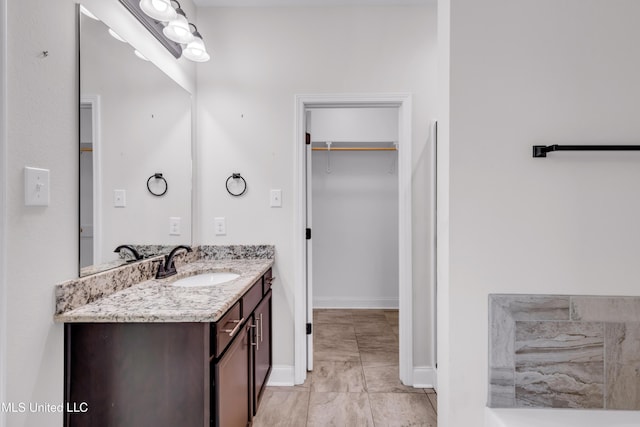 832 Reunion Place Cir, Biloxi, MS 39532 - full bath with vanity, a walk in closet, and baseboards