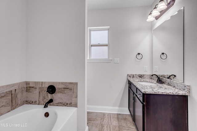 832 Reunion Place Cir, Biloxi, MS 39532 - bathroom featuring vanity, a bath, baseboards, and marble finish floors