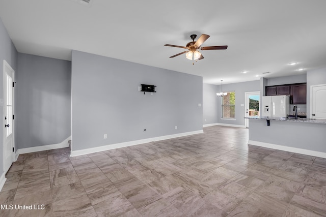 832 Reunion Place Cir, Biloxi, MS 39532 - unfurnished living room featuring a ceiling fan, a sink, a chandelier, baseboards, and recessed lighting