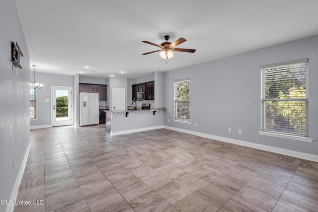 832 Reunion Place Cir, Biloxi, MS 39532 - unfurnished living room featuring healthy amount of natural light, a ceiling fan, a chandelier, baseboards, and recessed lighting