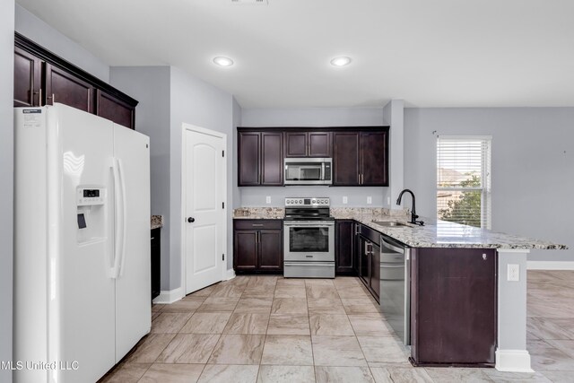 832 Reunion Place Cir, Biloxi, MS 39532 - kitchen featuring stainless steel appliances, a sink, a peninsula, baseboards, and light stone countertops