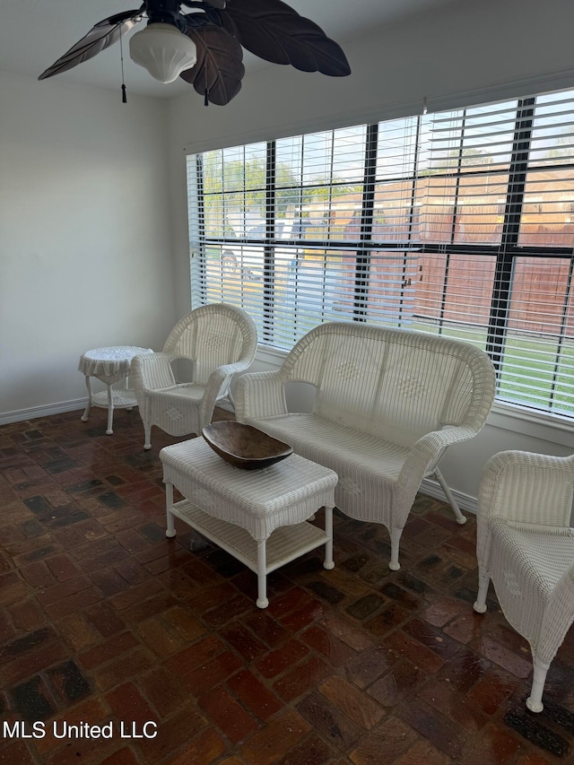 sunroom featuring ceiling fan