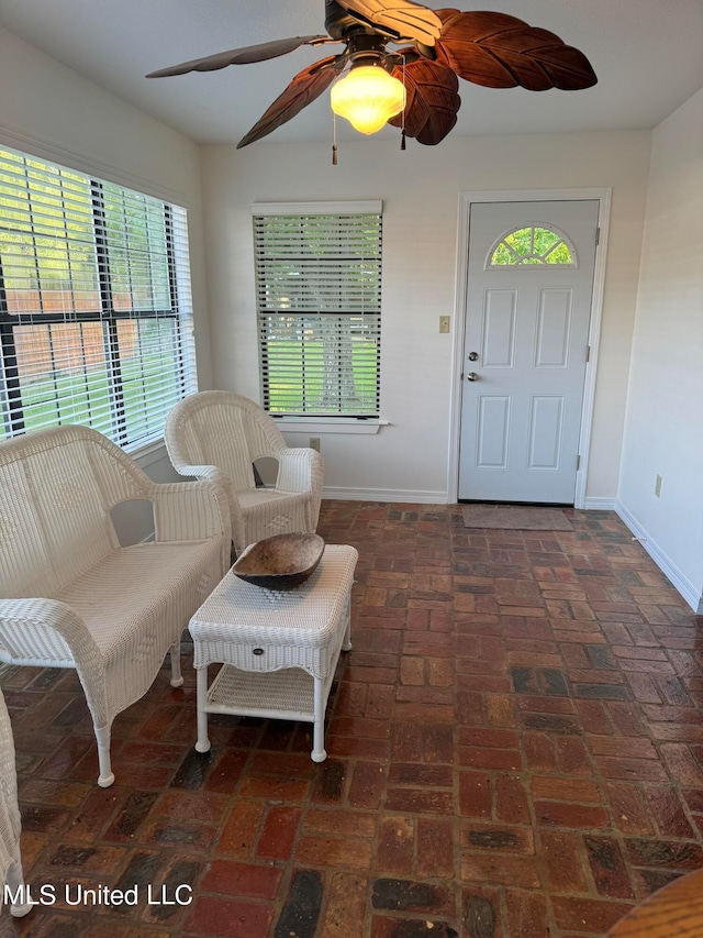 sitting room featuring ceiling fan