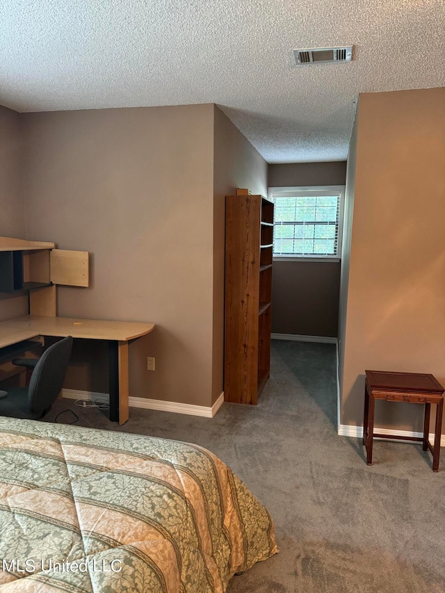 bedroom featuring a textured ceiling and carpet