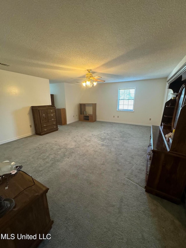 living room featuring a textured ceiling, carpet, and ceiling fan