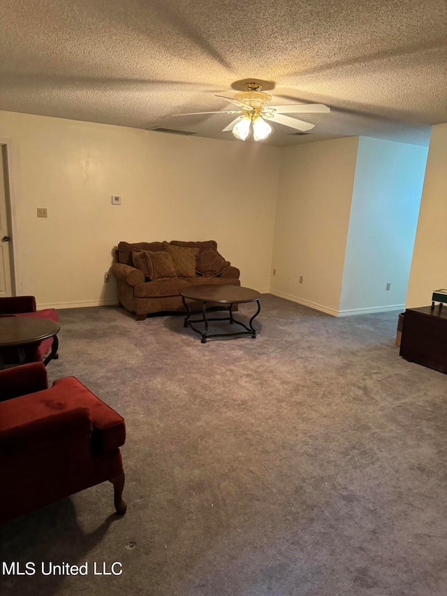 carpeted living room with a textured ceiling and ceiling fan