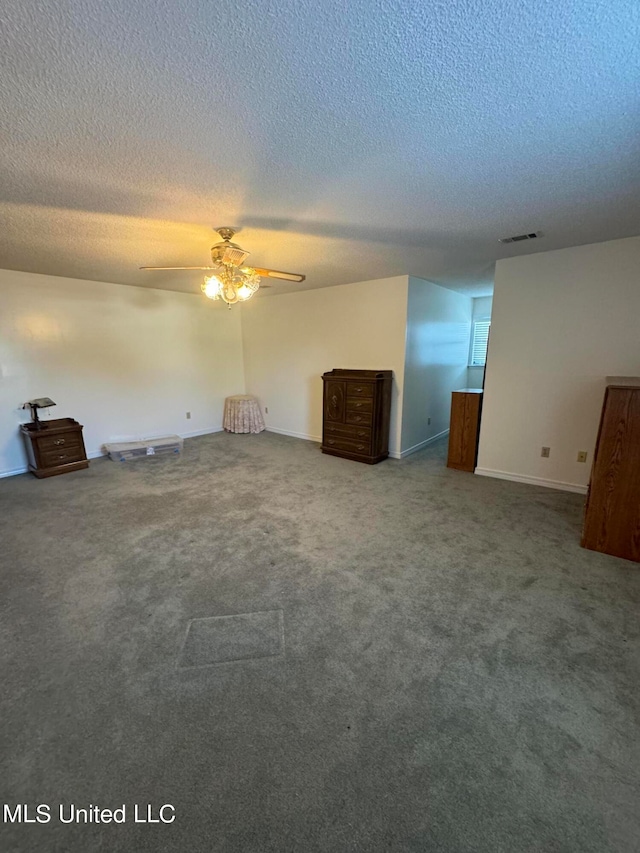 unfurnished bedroom featuring a textured ceiling, carpet floors, and ceiling fan