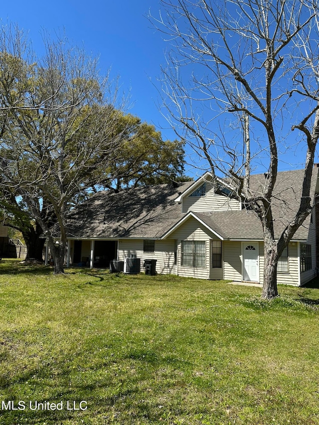 view of side of property with a lawn