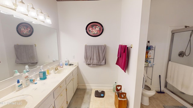 bathroom with vanity, toilet, tile patterned floors, and a shower with door