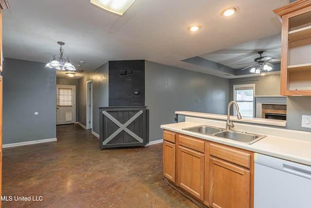 kitchen featuring dishwasher, ceiling fan with notable chandelier, sink, and decorative light fixtures