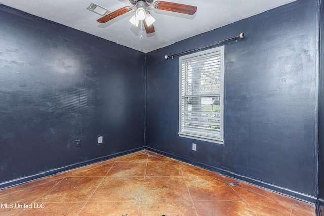 unfurnished room featuring tile patterned floors and ceiling fan