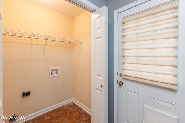 laundry room featuring dark tile patterned floors and hookup for a washing machine