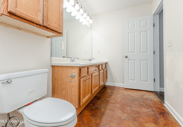 bathroom with tile patterned floors, vanity, and toilet