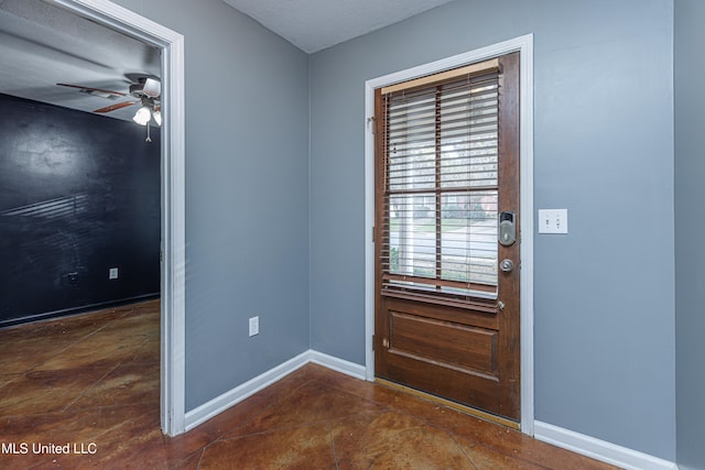 doorway to outside featuring a textured ceiling and ceiling fan