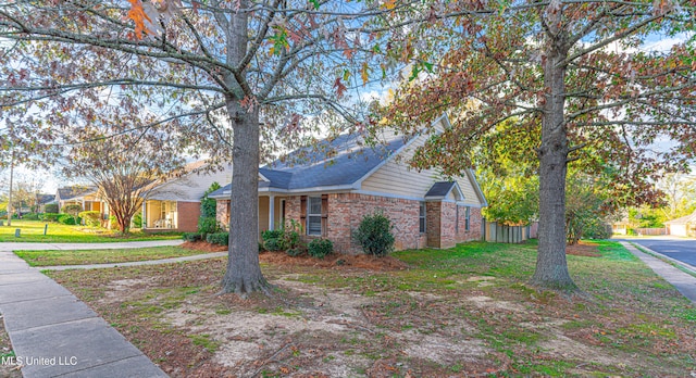 view of side of home featuring a lawn