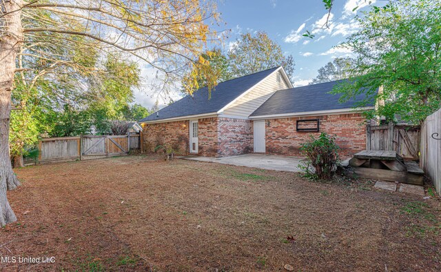 159 Basswood Cir, Brandon, MS 39047 - rear view of property featuring a gate, brick siding, a fenced backyard, and a patio area
