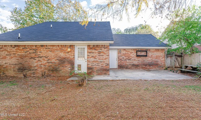 159 Basswood Cir, Brandon, MS 39047 - rear view of house featuring a patio, brick siding, and roof with shingles