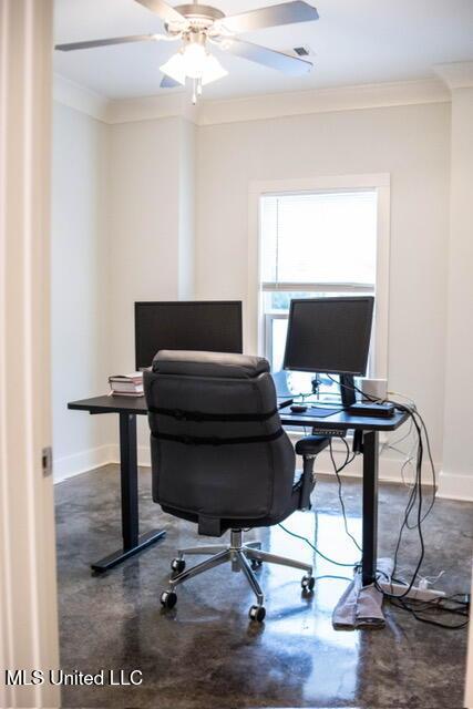 home office featuring finished concrete flooring, baseboards, ornamental molding, and ceiling fan
