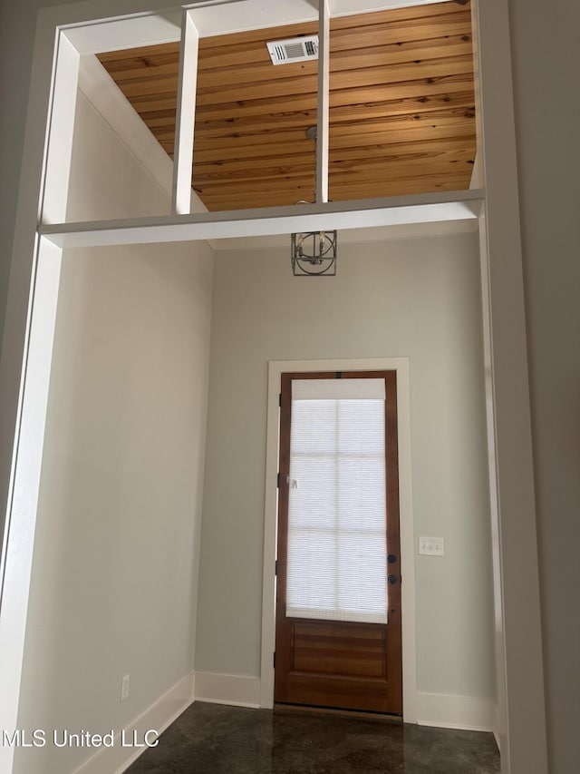 entryway featuring baseboards, visible vents, and finished concrete floors