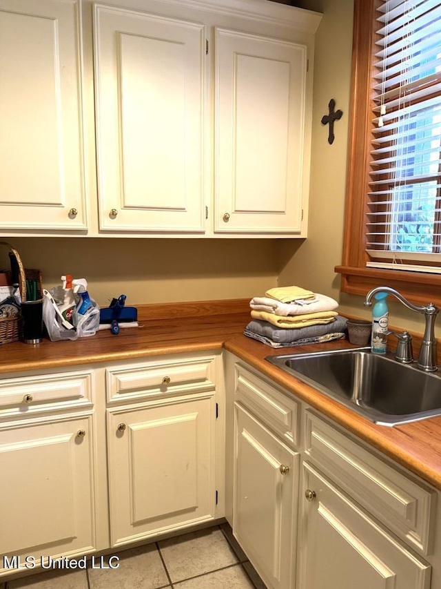 48 Fairway Dr, Natchez, MS 39120 - kitchen with white cabinetry, light tile patterned flooring, sink, and butcher block countertops