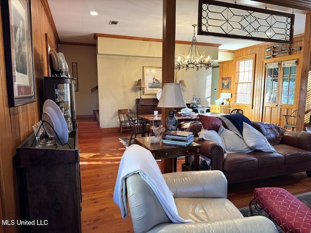 48 Fairway Dr, Natchez, MS 39120 - living room featuring crown molding, dark hardwood / wood-style floors, an inviting chandelier, and wood walls