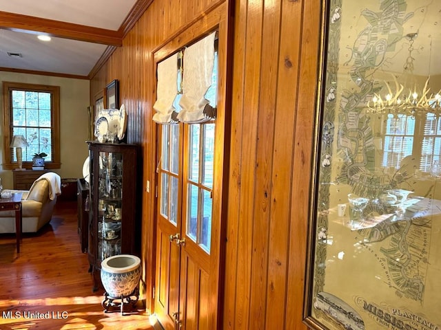 48 Fairway Dr, Natchez, MS 39120 - entryway with crown molding, wood-type flooring, and an inviting chandelier