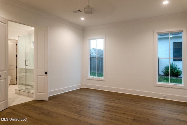 unfurnished room with ceiling fan, ornamental molding, a wealth of natural light, and dark hardwood / wood-style floors